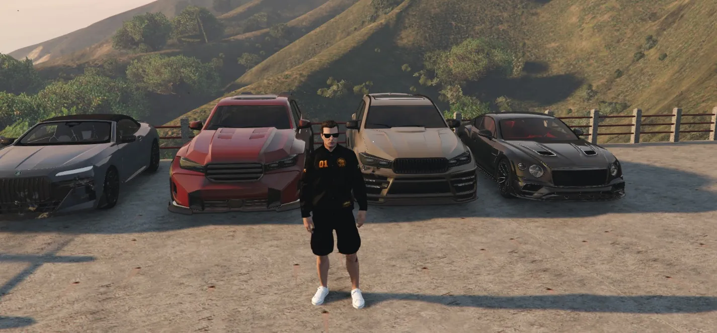 O 01 da Savage em frente à garagem da fac, com quatro carros importados
